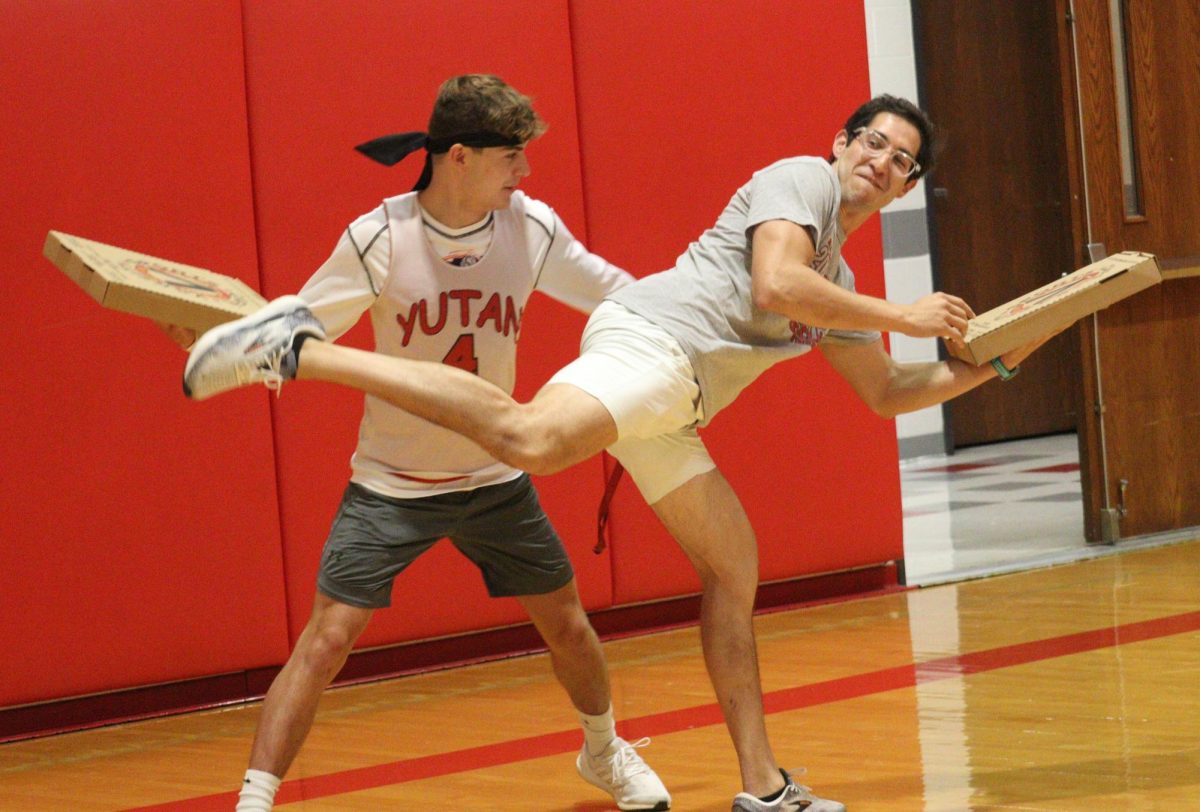 During the homecoming pep rally, senior Gionni Conti and math teacher Joel Carrillo battle it out in a “knock the pizza box” game. Every year the seniors play a game against the teachers, and this year the seniors won. “The pizza box game was fun, and I thought the pep rally was a good time,” Conti said.