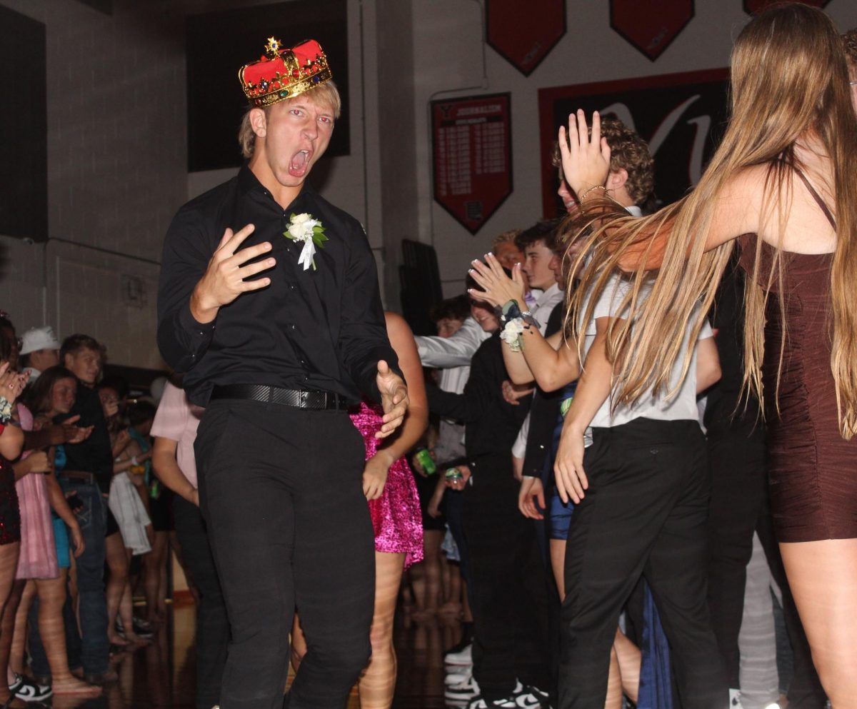  In his homecoming king crown, senior Tyler Keiser makes an entrance into the homecoming dance. At the beginning of the dance, the homecoming court was announced, and they made their way into the gym with all of the students cheering for them. “I had a lot of fun, and it was a relief knowing that I won,” Keiser said.
