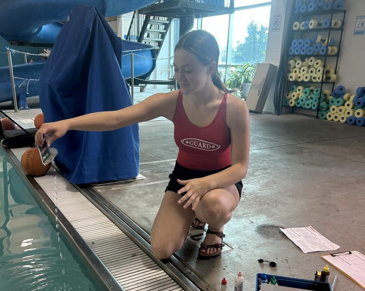 Senior Nicole Wacker checks the level of chemicals in the pool water. This was a part of her daily duties that got rotated between the other lifeguards.