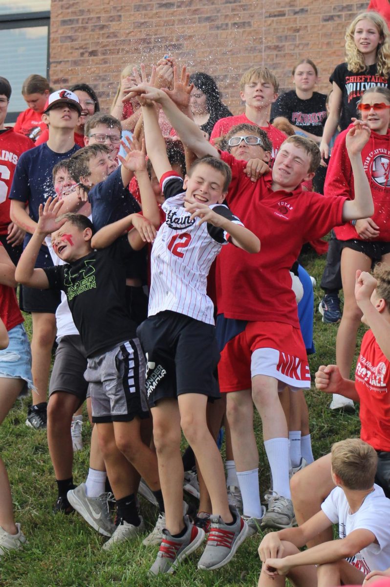 While watching the Chieftain Games, the seventh- and eighth-grade boys struggle in a skirmish to catch a water balloon being thrown into the crowd. The onlookers had been watching the games peacefully until balloons started being thrown at them. “I liked watching people throw water balloons at the football players,” seventh grader Korbin Karloff said. 