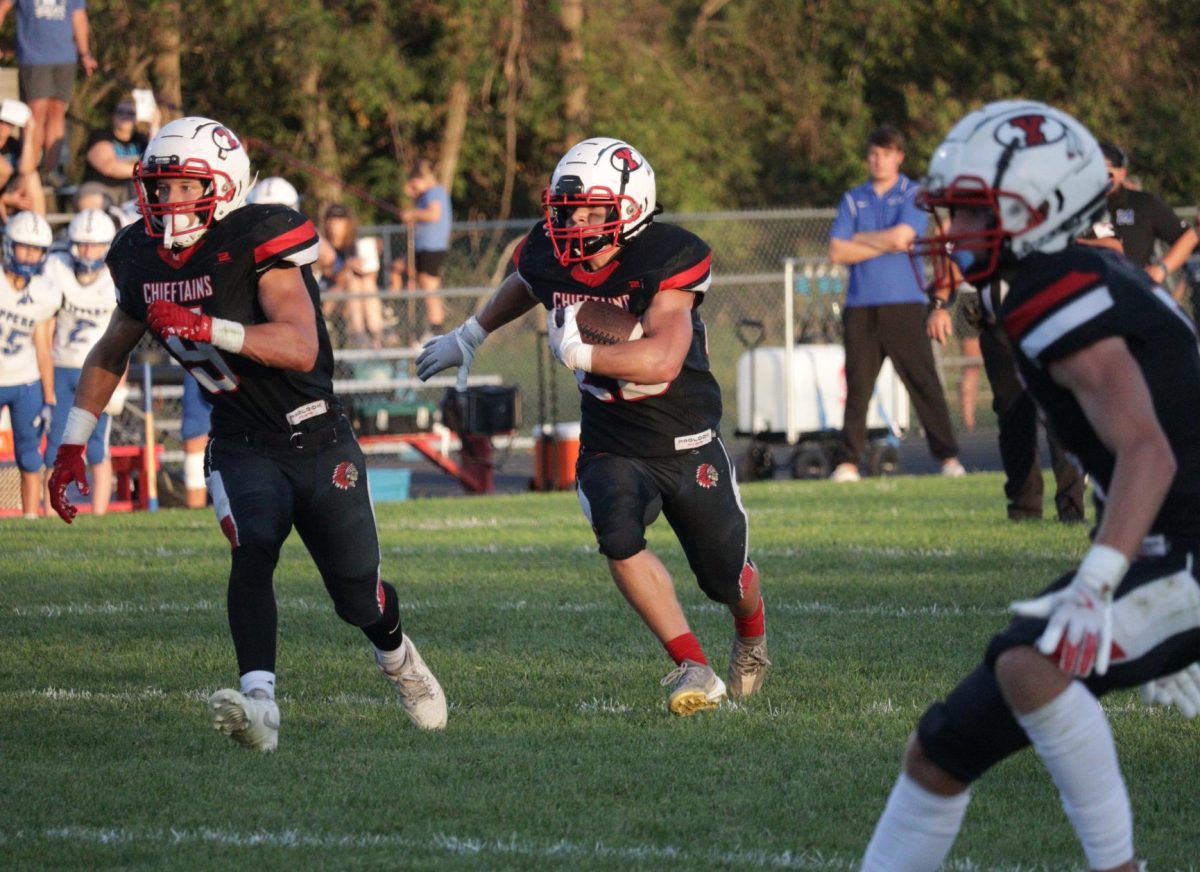 After receiving the ball on offense, sophomore Kaleb Fenner looks for gaps in Malcolm's defensive formation. At the running back position, Fenner led the team with 131 total rushing yards.