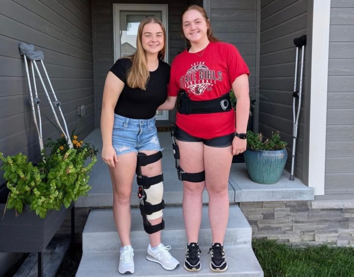 Senior Addi Smith and sophomore Kinsley Smith smile for their first day of school. In this picture, the sisters are almost one month post surgery. (Courtesy Photo)