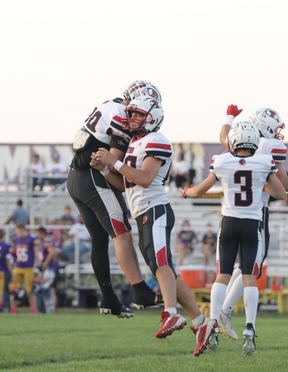 Senior Owen Sutter cheers with Richard Hays after a good play. Sutter had one 2 point conversion at Tekemah Herman