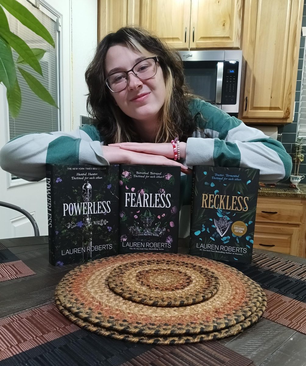 Freshman Ksenia Bradford displays the “Powerless Trilogy.” The novels took nearly a year for her to complete after waiting for the release of the latest book in the trilogy, “Fearless.”