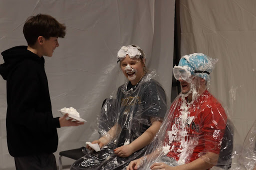 Eighth grader Griffin Ell gets ready to pie () in the face. One of the events at the carnival was a pie-in-the-face, where students were able to pie their teachers and fellow students.