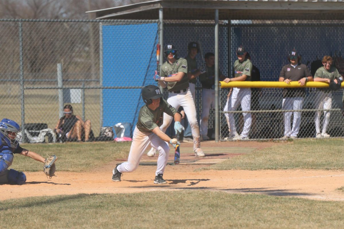 During the Malcolm game, junior Carson Hollst tries to bunt the ball. Hollst already ha 13 hits this season.