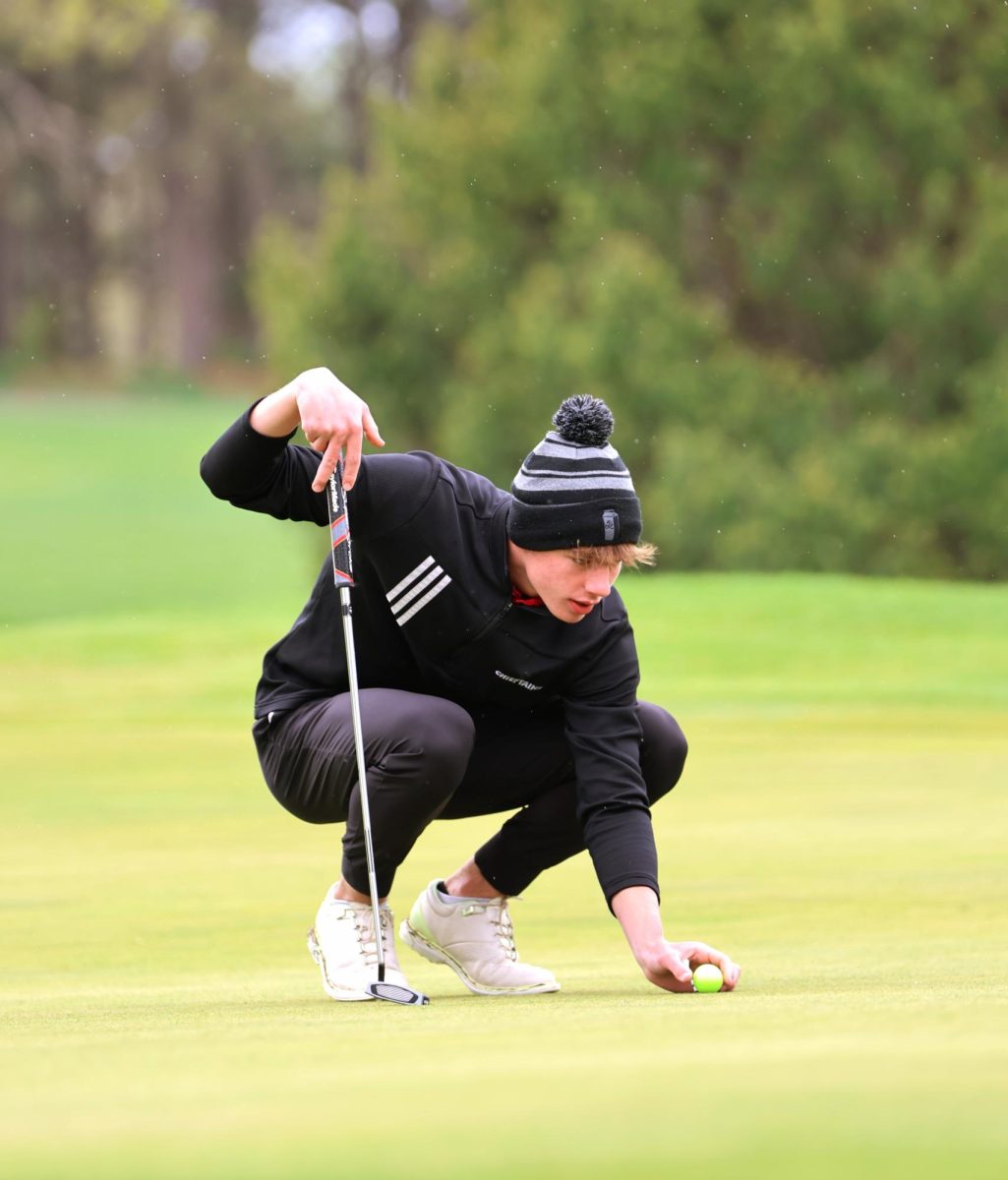 Senior Maddox Wentworth sets his ball down preparing for his turn. Wentworth is one of four seniors this season. 