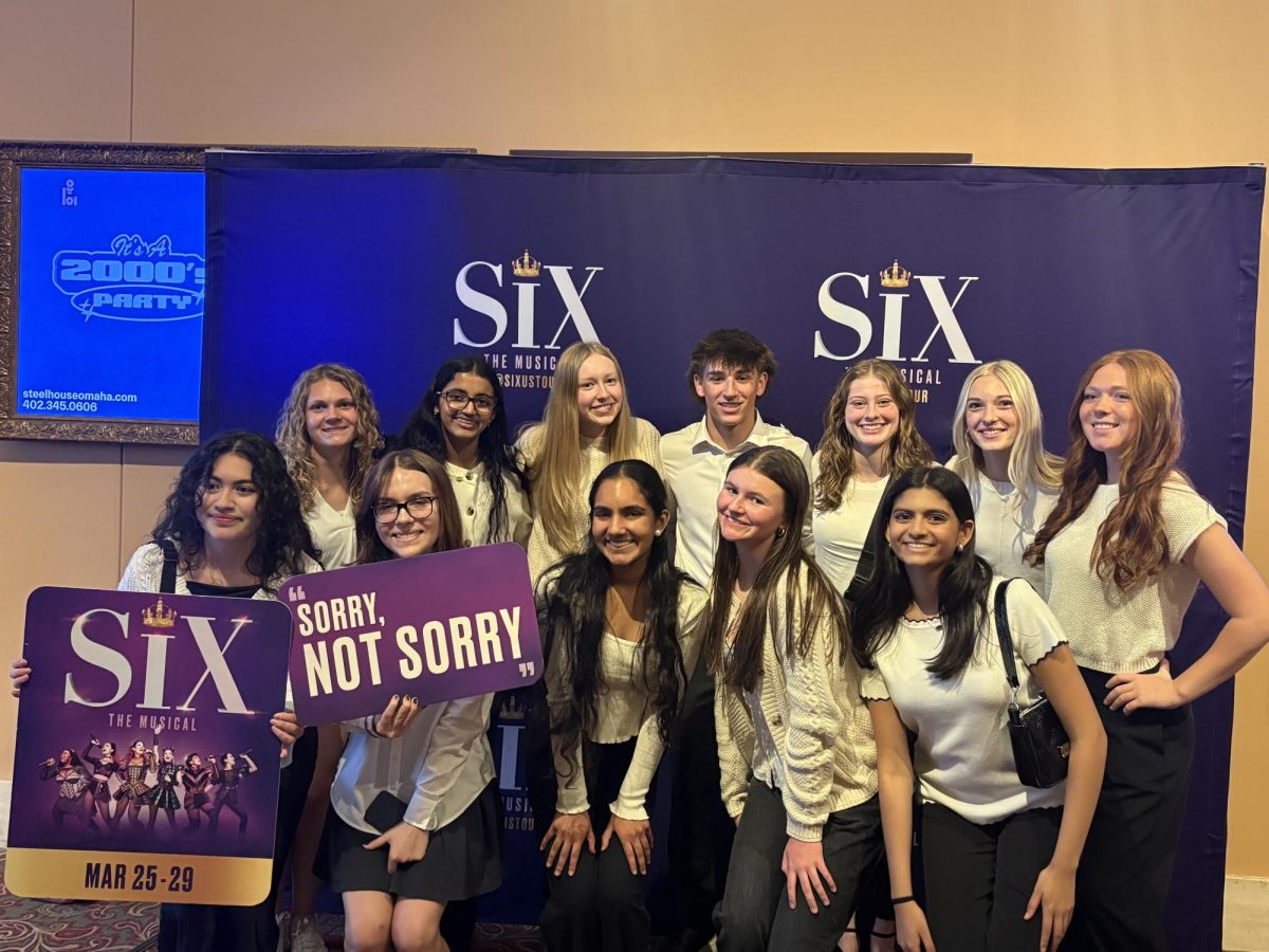 Sophomore Audrey Dieckman (second from right) poses with a volunteer group from Youth Leadership Omaha. The group had a quick tour of the Orpheum, and helped people find seats and handed out programs to audience members before being able to watch the show themselves.