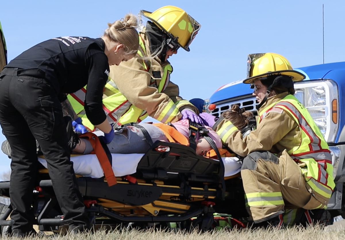 Junior Ella Henkel gets strapped down to a stretcher during the mock accident. Henkel was one of the actors who had to be sent to the emergency room.